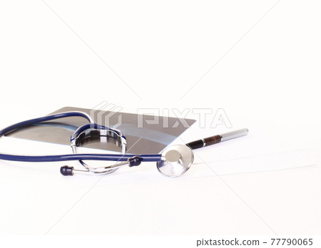 closeup. stethoscope,pen and an x-ray. isolated on white 77790065