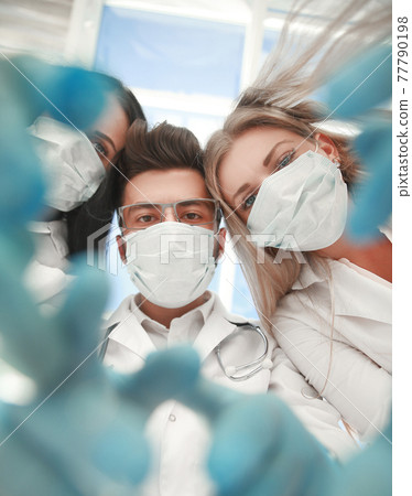 Team surgeons are performing an operation using medical instruments, in a modern operating room, Team surgeons are performing an operation using medical instruments, in a modern operating room, 77790198