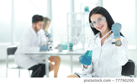 close up.female laboratory assistant takes a sample of the liquid close up.female laboratory assistant takes a sample of the liquid 77790200