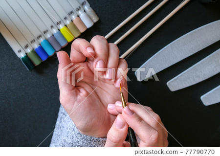 Work at home with nails. Nail care, Self care. Female manicure. Do manicure by yourself while staying at home. Female hands and manicure tools 77790770