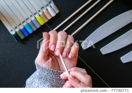 Work at home with nails. Nail care, Self care. Female manicure. Do manicure by yourself while staying at home. Female hands and manicure tools 77790771