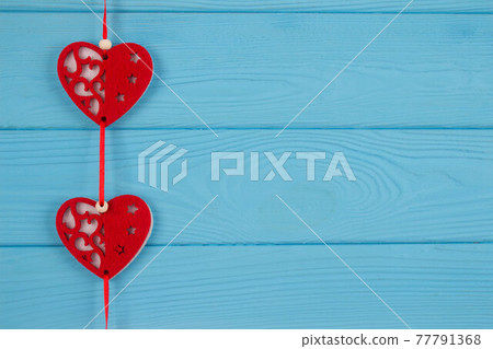 Woolen red hearts on blue wooden background with copy space for text. Valentine's Day celebration concept Woolen red hearts on blue wooden background with copy space for text. Valentine's Day celebration concept 77791368