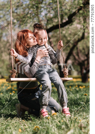 mom and her little daughter spend their free time together mom and her little daughter spend their free time together 77791905