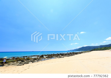 A beautiful view of the Amami Oshima coastline with a woman who came to see Heart Rock 77792362