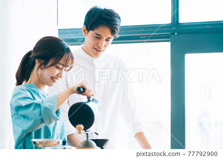 A couple making coffee in the kitchen A couple making coffee in the kitchen 77792900