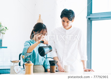A couple making coffee in the kitchen A couple making coffee in the kitchen 77792901