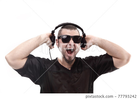 close up. stylish rapper shows headphones .isolated on white 77793242