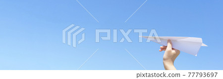 A child flying a paper airplane 77793697