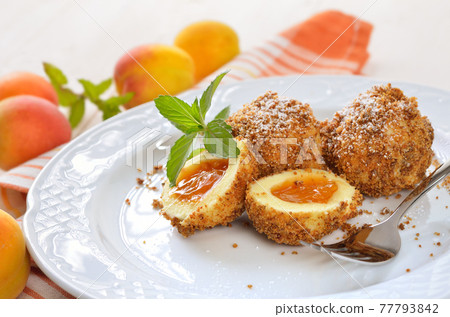 Sweet apricot dumplings, an Austrian cooked dessert 77793842
