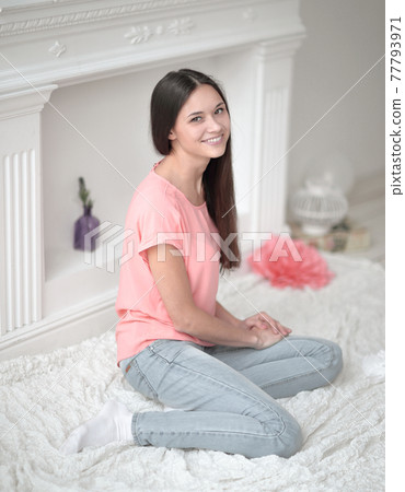 close up.young girl sitting on floor in living room 77793971
