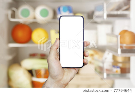 Online grocery delivery app in a mobile phone. Food market service in smartphone. Grocery delivery background concept. Shopping cart. Empty blank screen 77794644