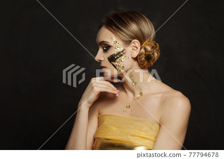 Fashion beauty portrait of stylish woman with golden makeup on black background Fashion beauty portrait of stylish woman with golden makeup on black background 77794678