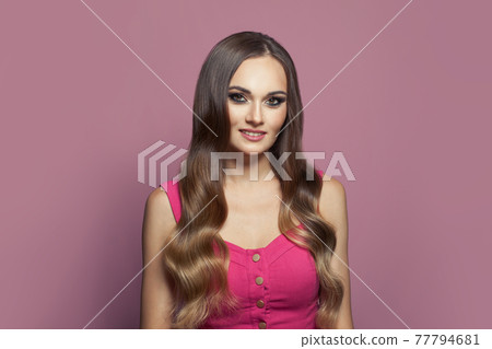 Glamorous fashion model woman with long healthy hair and clear skin on pink background Glamorous fashion model woman with long healthy hair and clear skin on pink background 77794681