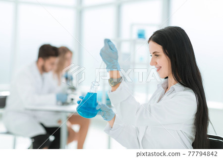 close up.female laboratory assistant takes a sample of the liquid close up.female laboratory assistant takes a sample of the liquid 77794842