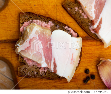 Snack for vodka, homemade salo with bread and horseradish Snack for vodka, homemade salo with bread and horseradish 77795039