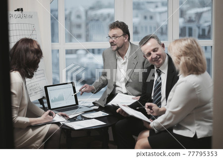 successful business partners discussing a new contract successful business partners discussing a new contract 77795353