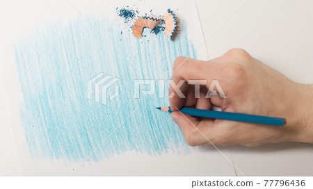 closeup.the artist drawing with a blue pencil on a white sheet closeup.the artist drawing with a blue pencil on a white sheet 77796436