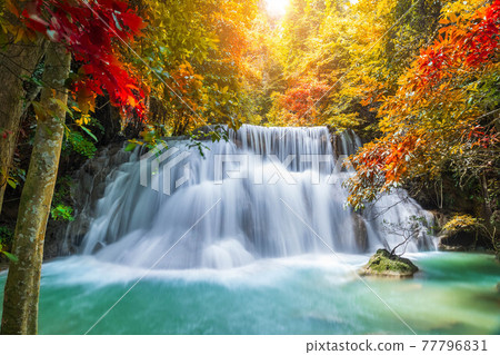 Colorful majestic waterfall in national park forest during autumn - Image 77796831