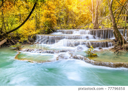 Colorful majestic waterfall in national park forest during autumn - Image 77796858