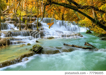Colorful majestic waterfall in national park forest during autumn - Image Colorful majestic waterfall in national park forest during autumn - Image 77796895