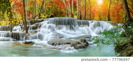 Colorful majestic waterfall in national park forest during autumn, panorama - Image 77796897