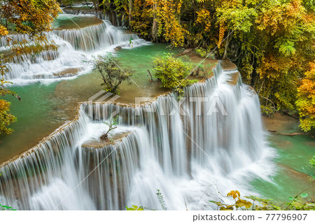 Colorful majestic waterfall in national park forest during autumn - Image 77796907