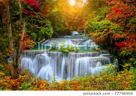 Colorful majestic waterfall in national park forest during autumn - Image 77796909
