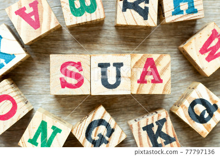 Alphabet letter block in word SUA (Abbreviation of Single use account) with another on wood background 77797136