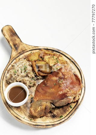SCHWEINSHAXE traditional german pork knuckle with sauerkraut and potatoes meal SCHWEINSHAXE traditional german pork knuckle with sauerkraut and potatoes meal 77797270