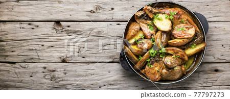Chicken baked with potatoes in a pan Chicken baked with potatoes in a pan 77797273