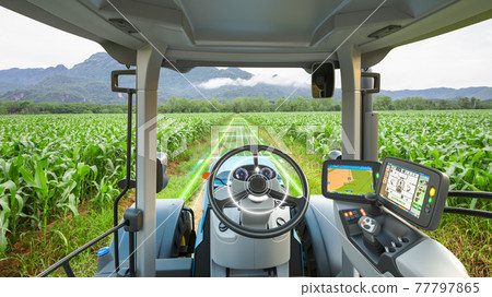 5G autonomous tractor working in corn field, Future technology with smart agriculture farming concept 77797865
