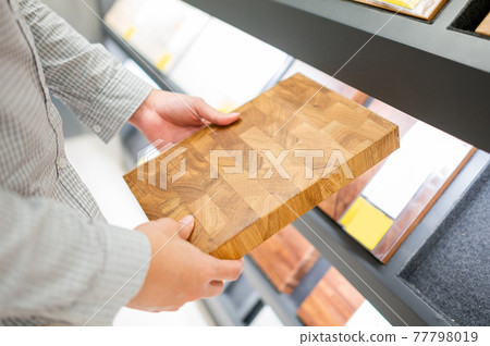 Male hand choosing cabinet or countertop material Male hand choosing cabinet or countertop material 77798019