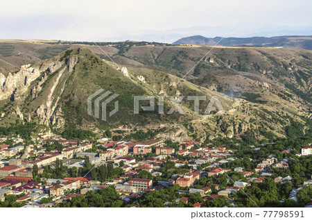 The medieval city of Goris at sunset located in a mountain hollow among rocks with caves The medieval city of Goris at sunset located in a mountain hollow among rocks with caves 77798591