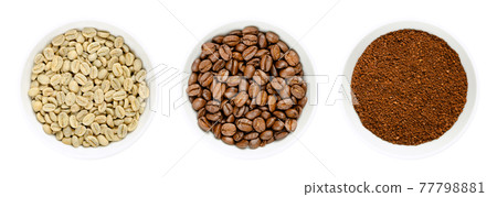 Green, roasted and ground coffee beans in white bowls. Seeds of berries from Coffea arabica, also Arabian, mountain or arabica coffee. Unroasted and roasted pits and coffee powder. Closeup food photo. 77798881