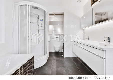 Spacious bathroom with white furniture 77799108