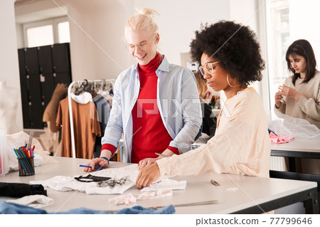 Man creating something new from the old clothes while recycling and re sewing Man creating something new from the old clothes while recycling and re sewing 77799646
