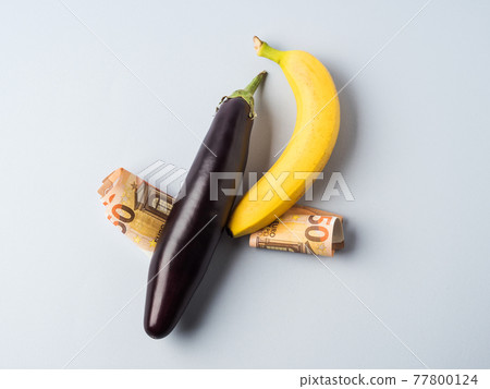 Euro banknotes 50 value with banana on gray. Paid sex concept Euro banknotes 50 value with banana on gray. Paid sex concept 77800124
