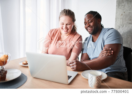 Couple feeling relieved and rested while having breakfast together Couple feeling relieved and rested while having breakfast together 77800401