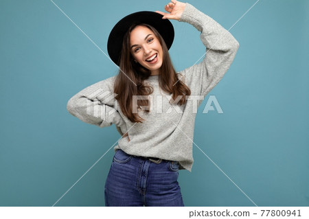 Photo of young positive happy smiling beautiful woman with sincere emotions wearing stylish clothes 77800941