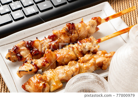 Online drinking party image. Yakitori (sauce), sake and keyboard. Online drinking party image. Yakitori (sauce), sake and keyboard. 77800979