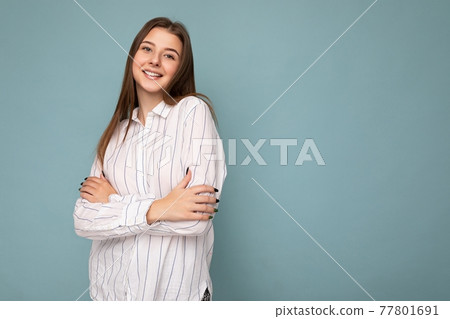 Adult smiling beautiful brunette woman with sincere emotions isolated on background wall with copy 77801691