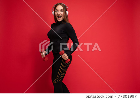 Side-profile photo of beautiful positive smiling young brunette woman wearing black sport clothes Side-profile photo of beautiful positive smiling young brunette woman wearing black sport clothes 77801997