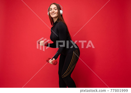 Side-profile photo of attractive positive smiling young brunette woman wearing black sport clothes 77801999