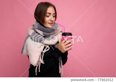 Beautiful sick sad young brunette woman wearing black sweater and warm scarf isolated over pink Beautiful sick sad young brunette woman wearing black sweater and warm scarf isolated over pink 77802012