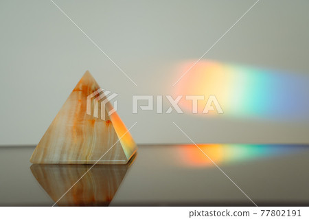 Agate pyramid with a rainbow streak background 77802191