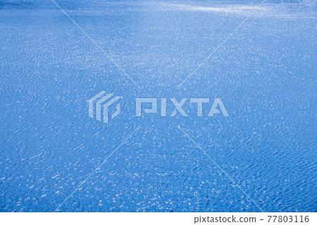 The blue water surface where the sunlight shines The blue water surface where the sunlight shines 77803116