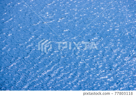 The blue water surface where the sunlight shines The blue water surface where the sunlight shines 77803118