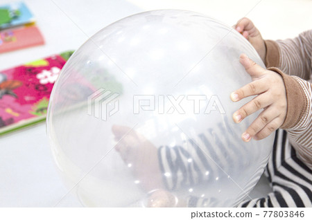 child's hand holding a balloon child's hand holding a balloon 77803846