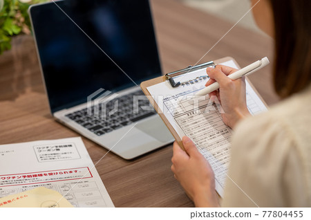 Image of a woman looking at vaccination notice 77804455