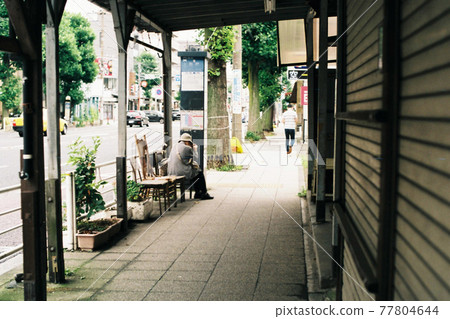 Grandmother waiting for the bus 77804644